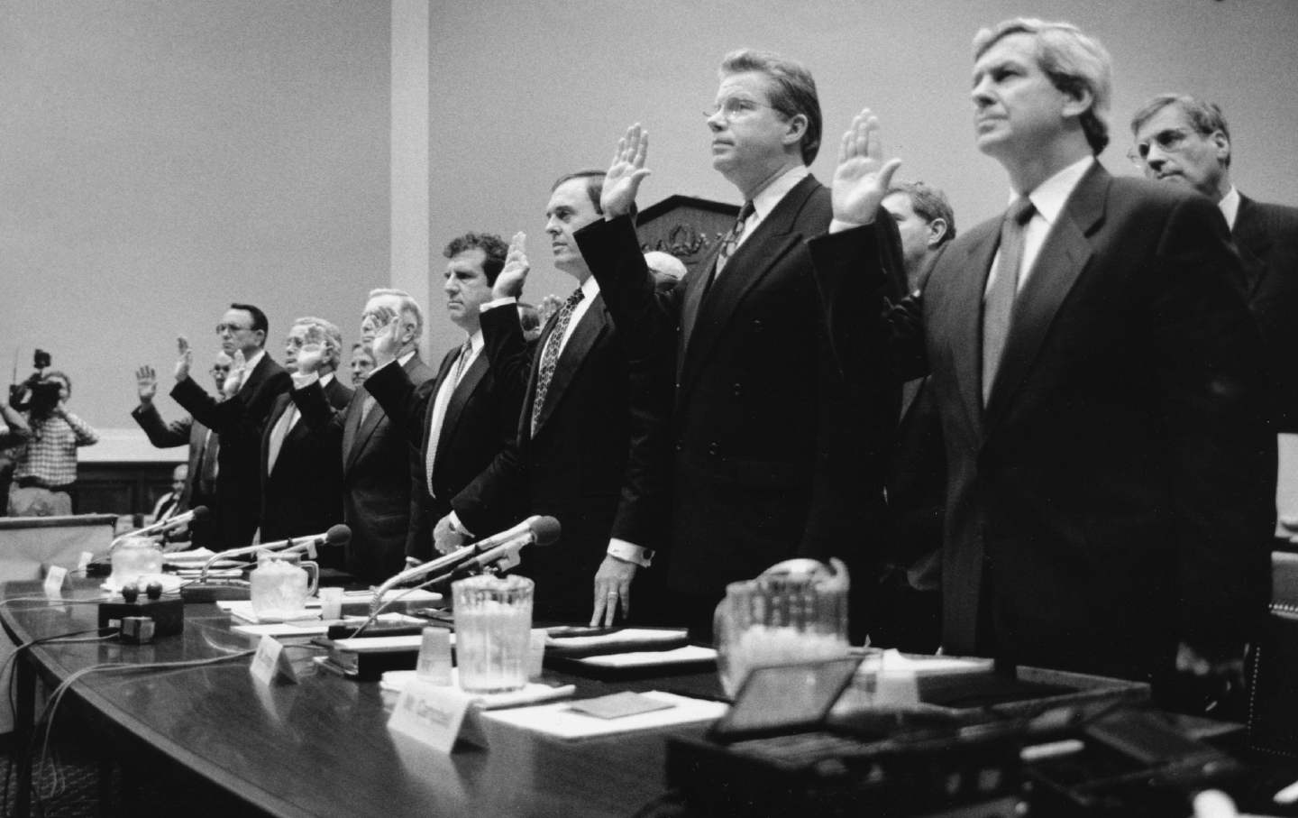 Seven tobacco company CEOs raising their right hands to be sworn in before Congress, 1994